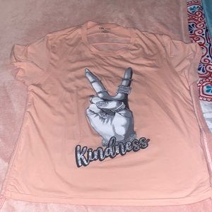 This shirt is a peach pink color and the size is 1x